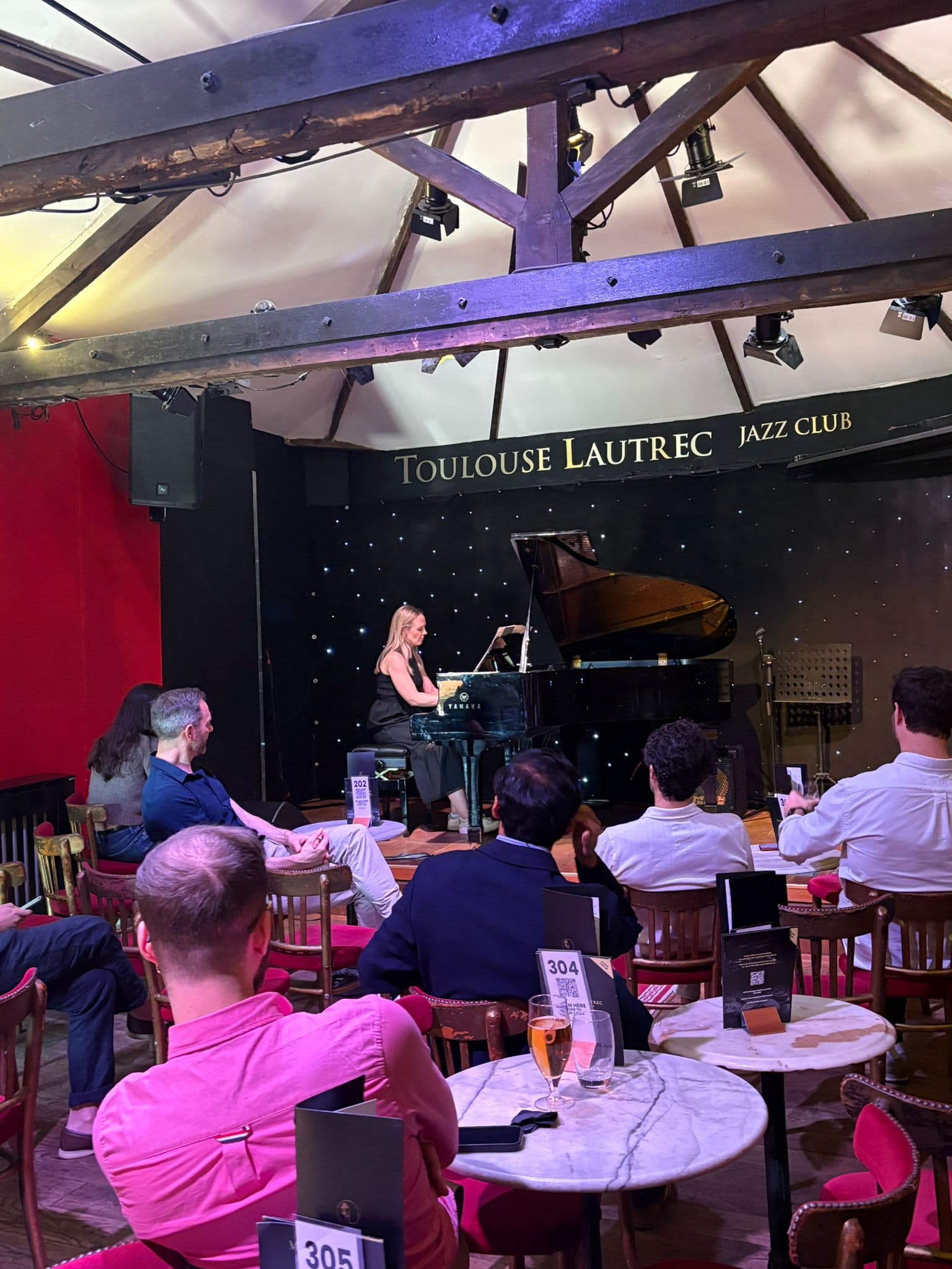 A student performing on the grand piano at our April student social